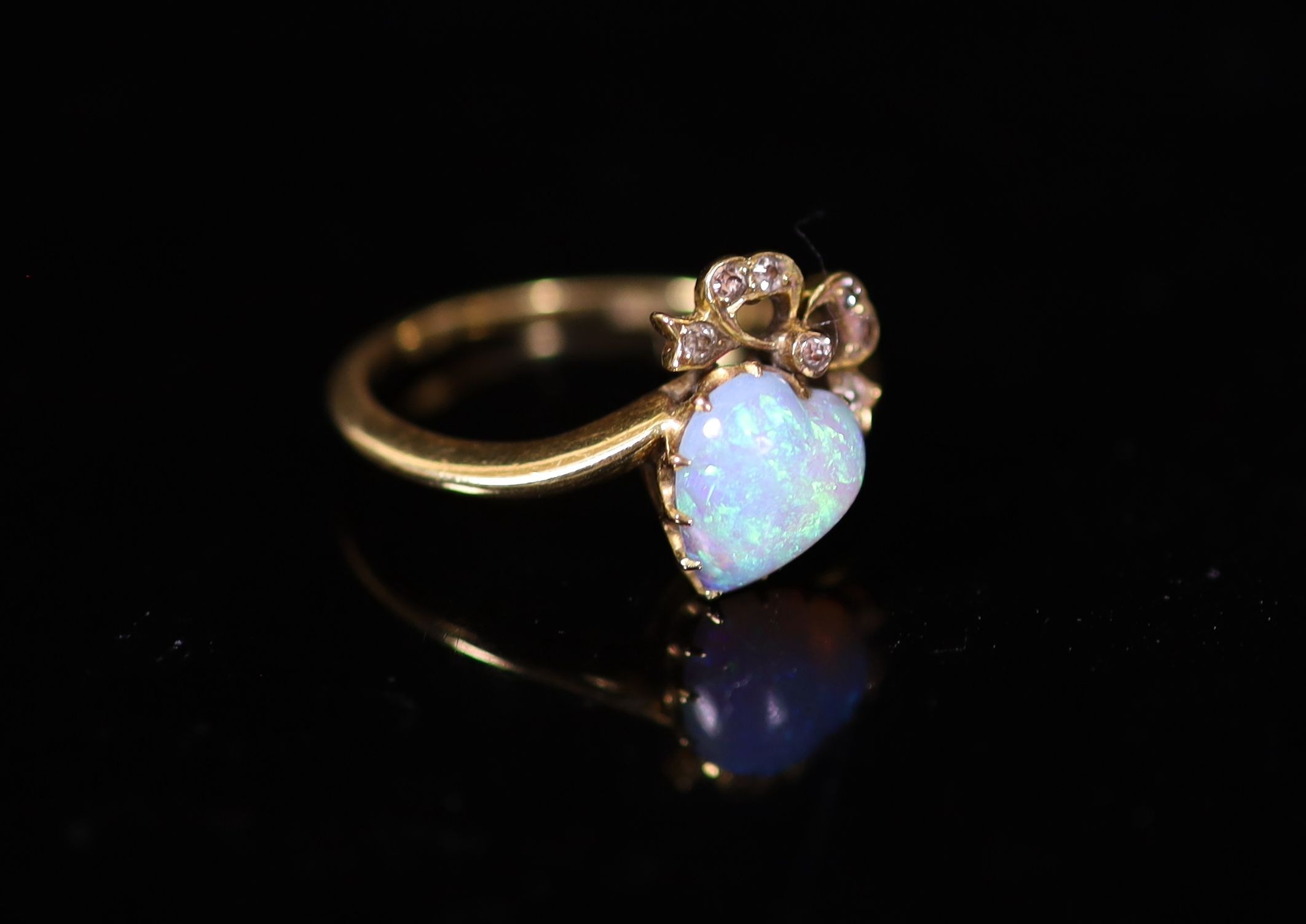 A late Victorian gold, heart shaped opal and diamond set crossover ring